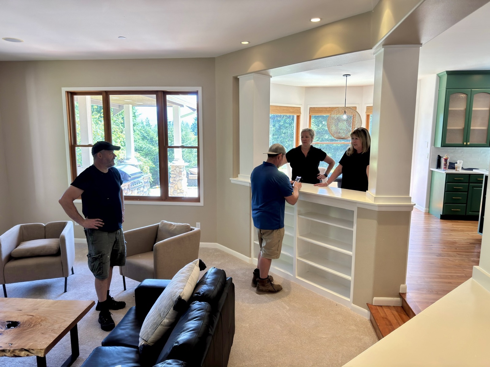 Agents and a stager walking a staged living room before the shoot